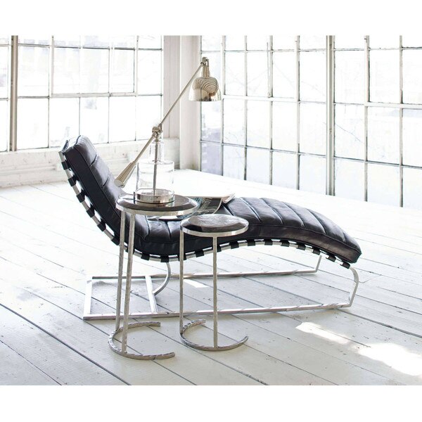 leather chaise lounge next to a polished silver side table